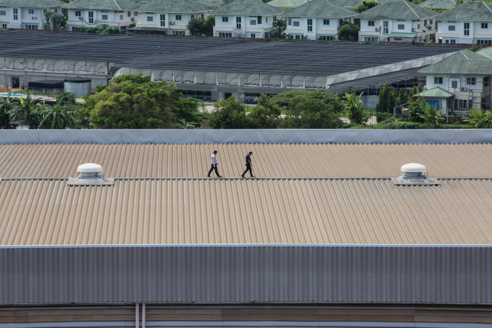 Engineer,Inspects,The,Factory,Roof.