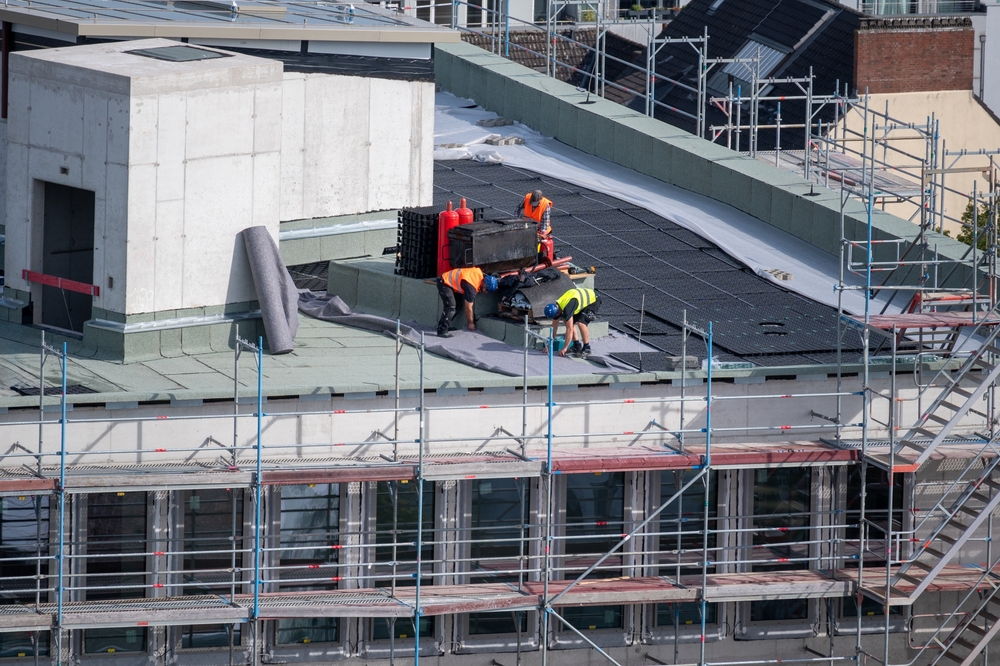 Birdseye,View,Of,Roofer,Waterproofing,The,Flat,Roof,Of,A