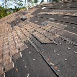 Wind,Damaaged,House,Roof,With,Missing,Asphalt,Shingles,After,Hurricane