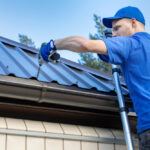 Metal,Roofing,-,Roofer,Working,On,The,House,Roof