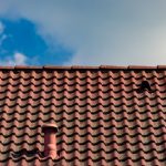Red,Roof,Tiles,Against,Cloudy,Sky,With,Small,Chimney,And